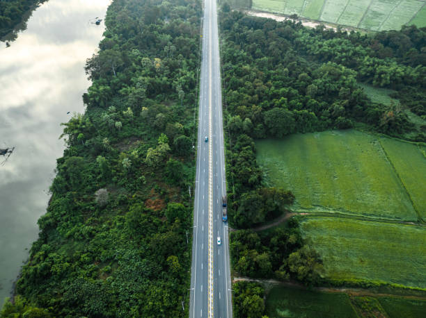 istock A long straight road leading through rural countryside with beautiful forest. 1453006516