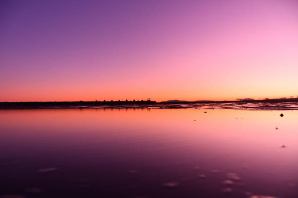 Water mirror and sunset on the sandy beach.\nChigasaki Beach in Chigasaki, Kanagawa Prefecture, Japan.