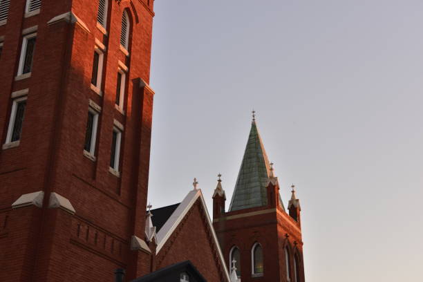 istock Rising Sun Peeking On Brick Church Steeple 1453008490