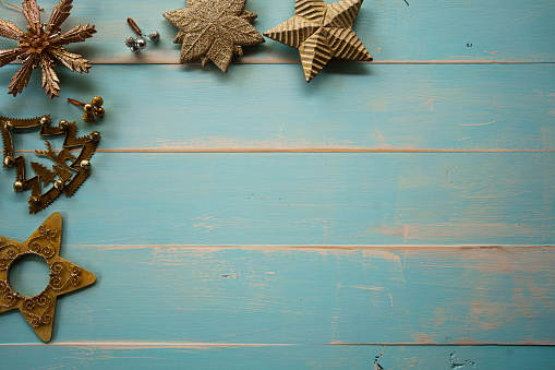 Christmas decorations and ornaments flat lay on a pale blue timber whitewashed vintage board
