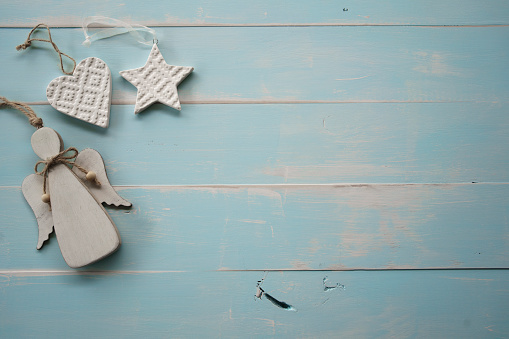 Christmas decorations and ornaments flat lay on a pale blue timber whitewashed vintage board