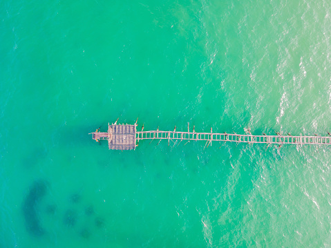 Turquoise water and concrete jetty pier, drone shot.