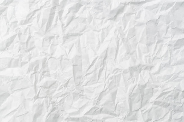 istock Wrinkled or crumpled white stencil paper or tissue after use with large copy space used for background texture in decorative art work 1453035909
