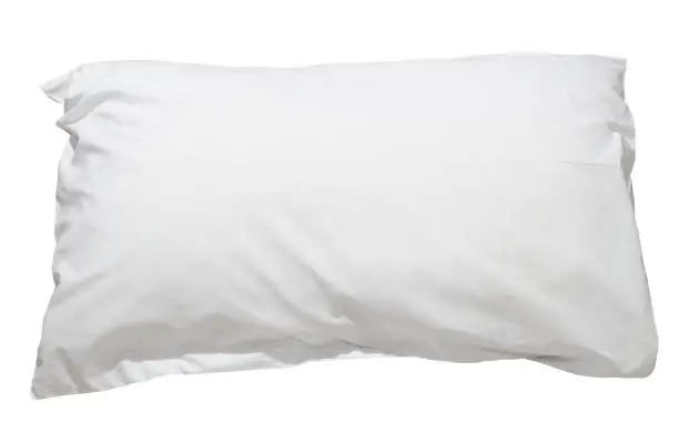 White pillow with case after guest's use at hotel or resort room is isolated on white background with clipping path. Concept of confortable and happy sleep in daily life