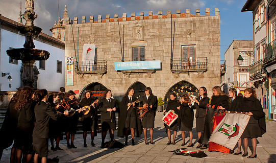 Viana do Castelo, Portugal-November 27, 2010: Group of university female tuna singers and players in front of ancient Town Hall building in Praça da República,  Viana do Castelo, Portugal.