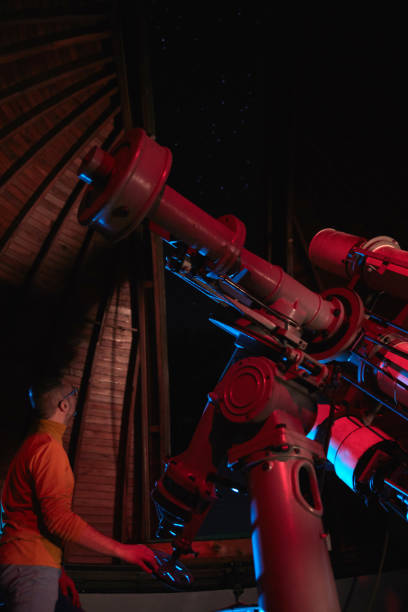 istock Astronomer with a big astronomical telescope in observatory doing science research of space and celestial objects. 1453044784