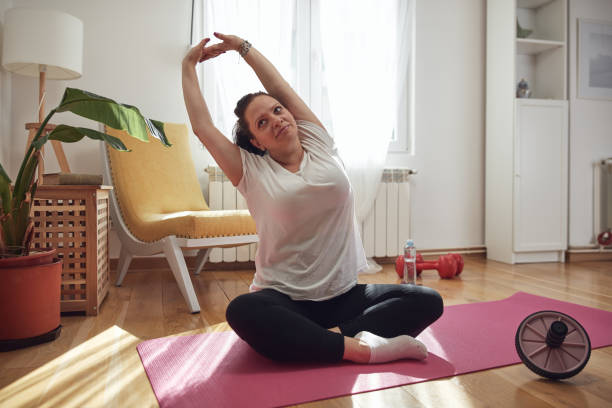 istock Woman training inside the living room, exercising at home. 1453046042