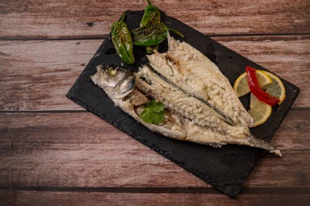istock fresh sea bass cooked in salt on a black board 1453046370