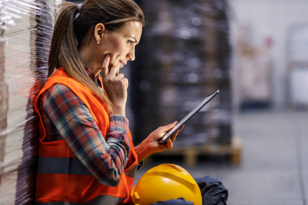 istock Thoughtful storage worker is looking at the tablet and tracking shipment online. 1453047017