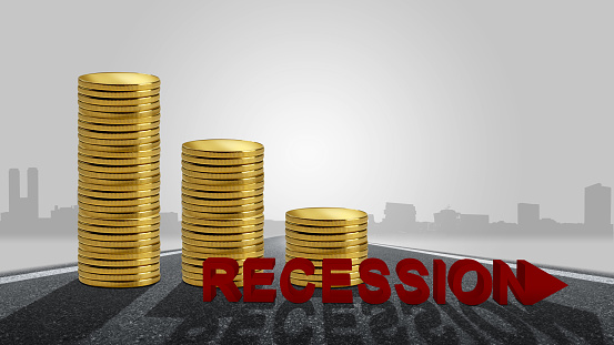 Stack of coins with recession sign with cityscape background