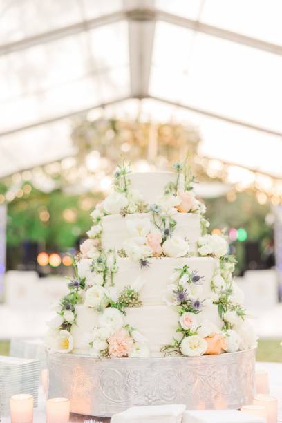 istock Vertical shot of a beautiful wedding cake decorated with roses on a table 1453047971
