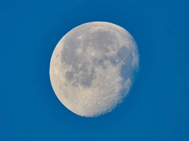 istock Closeup shot of a almost full moon over a blue background 1453048056