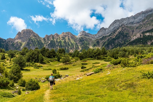 A young woman trekking to the Piedrafita arch in the Pyrenees in Panticosa, Aragon