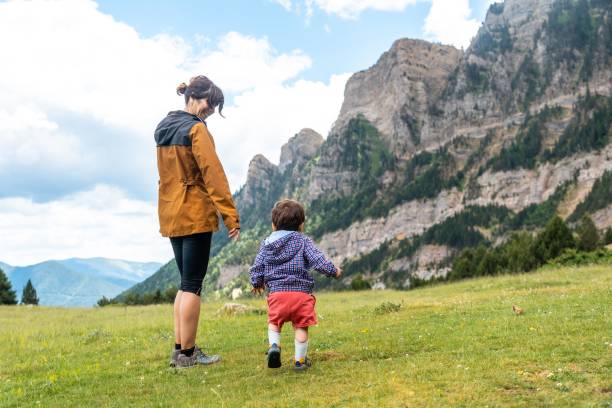 istock Mother with her son walking in the wild nature 1453049703