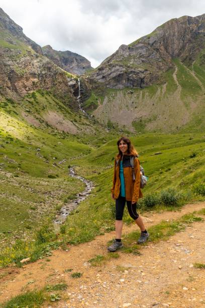 istock Young woman visiting the waterfall in the valley 1453049792