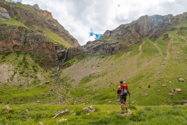 istock Young man in the mountain trekking with his son in the backpack 1453049828