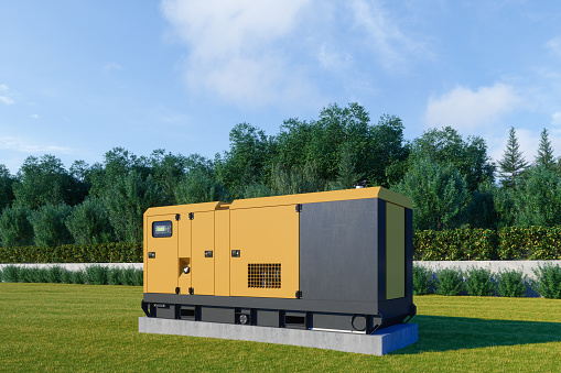 Close-up View Of Mobile Diesel Generator On Grass With Forest Background