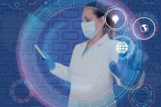 istock Nurse in uniform pointing upwards at holograms representing global innovative thinking. 1453050173