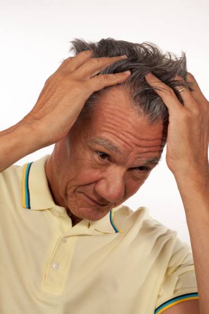 istock Mature man running his hands through his hair 1453050187