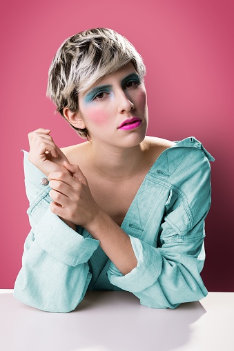 A female model with makeup posing in a studio