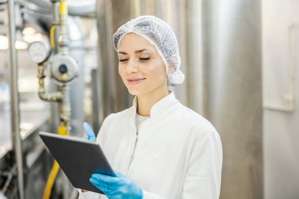 istock A milk plant supervisor is digitally starting machine for milk processing. 1453051135