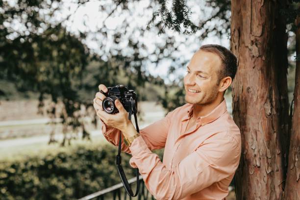 istock Photographer taking photo on an old vintage camera 1453051147
