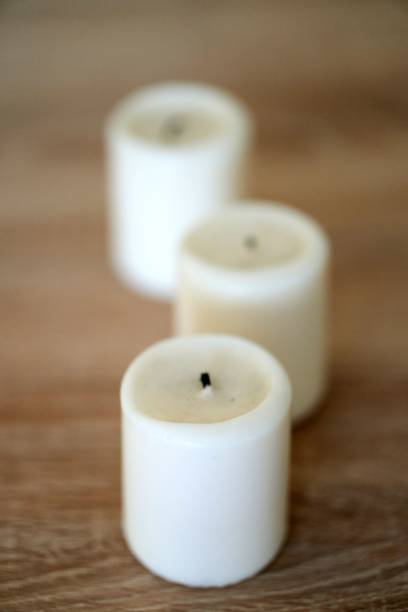 istock Vertical selective focus shot of a candle on a wooden background 1453055635