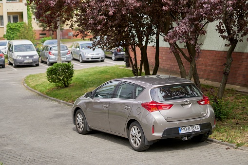 Poznan, Poland – May 22, 2022: A parked new car next to an apartment building in the Stare Zegrze district, Poznan, Poland
