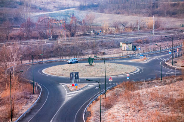Turin, Italy - January 30, 2019: Roundabout with one car and a railroad