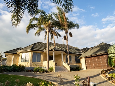 Auckland, New Zealand – May 23, 2022: View of suburban house with palms