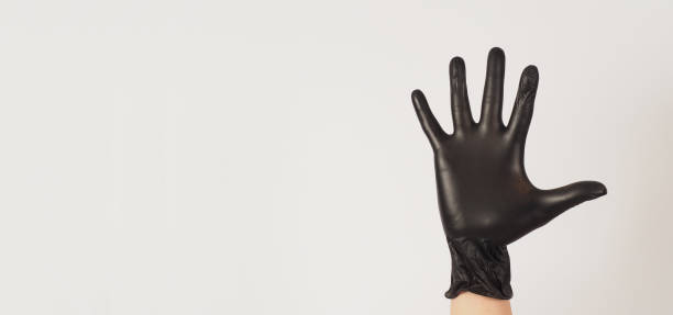 istock Empty Hand is wear black latex gloves on white background. 1453059127