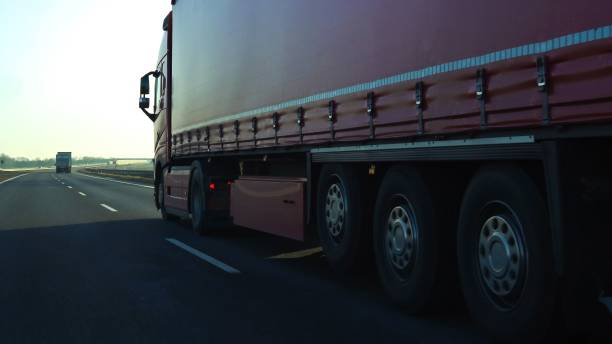 istock Long vehicle trailer truck on a highway with motion blur effect. 1453060085