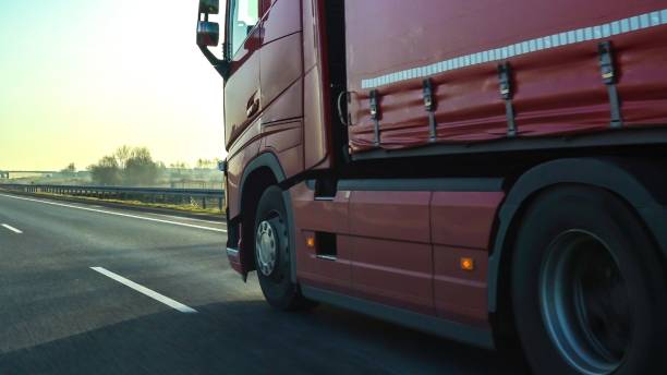 istock Long vehicle trailer truck on a highway with motion blur effect. 1453060091