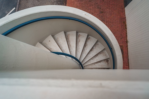 A top view of a modern white spiral staircase