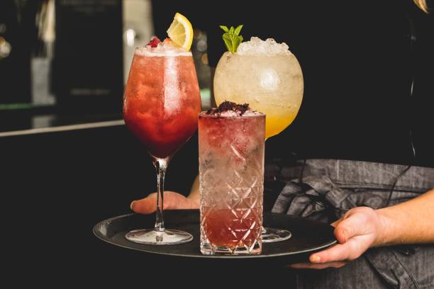 istock Waiter serving different cocktails on a tray 1453063171