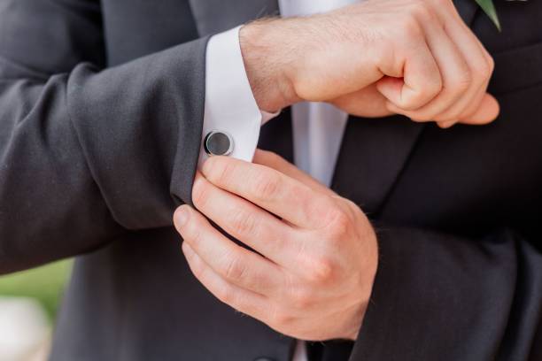 istock Close up of a groom clasping cufflinks 1453069325