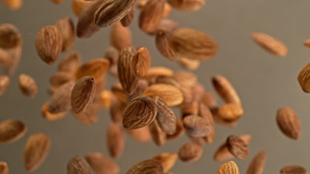 Super slow motion of rotating almonds up to the air.