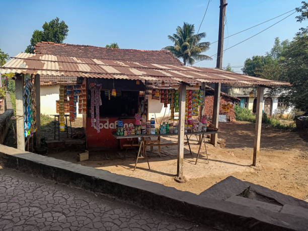 Stock photo of old style Kirana shop or grocery shop in the indian village, verity of food, grain, spices snacks kept in display for customer.blue sky on background stock photo
