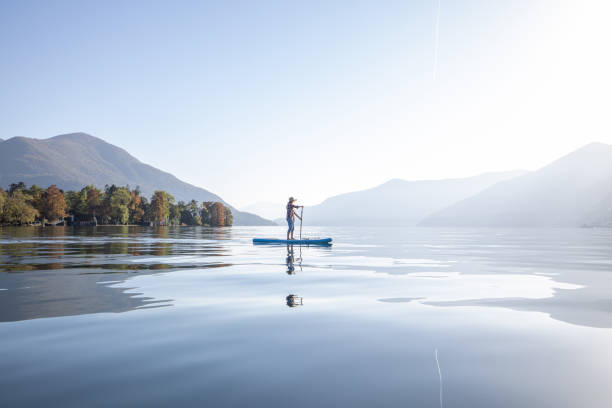 istock Woman stand up paddling on a lake 1453083214
