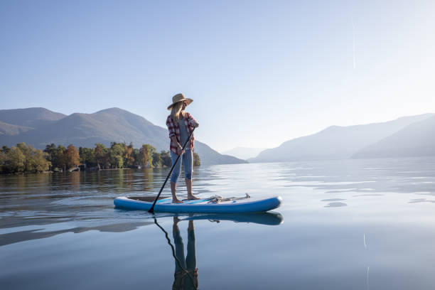 istock Woman stand up paddling on a lake 1453083216