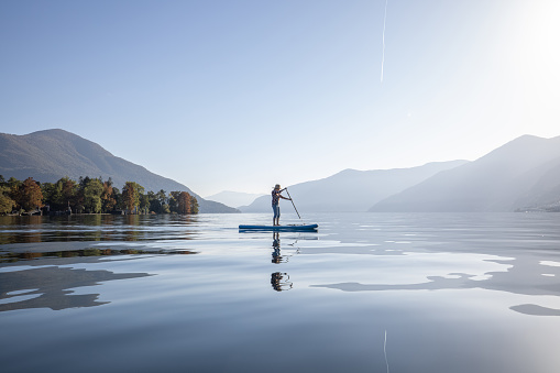 Woman stand up paddling on a lake