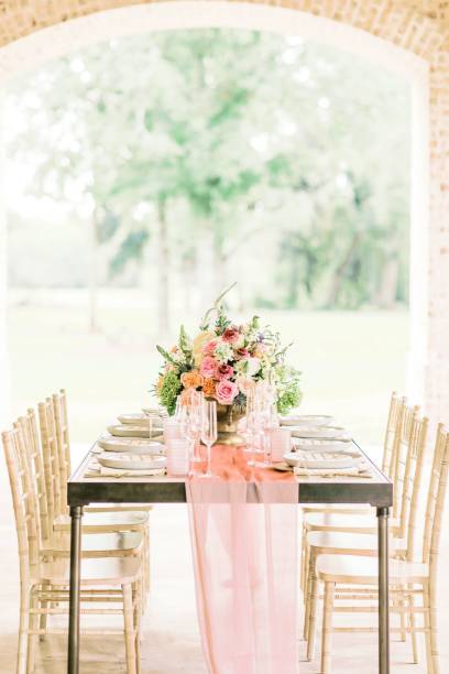 istock Vertical shot of a wedding table with elegant tableware and a bouquet with a blurred background 1453086701