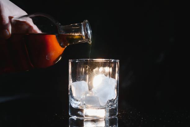 istock Whiskey glass black background shiny 1453086718