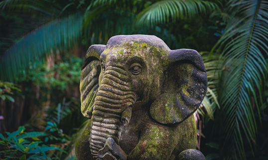 Ganesha made of stone in the jungle of Bali, Indonesia.