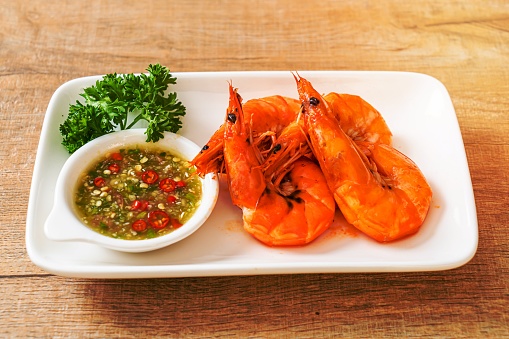 baked salted shrimps or prawns with seafood spicy sauce - seafood style
