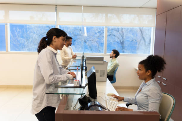 istock Female patient checking in at hospital reception 1453088014