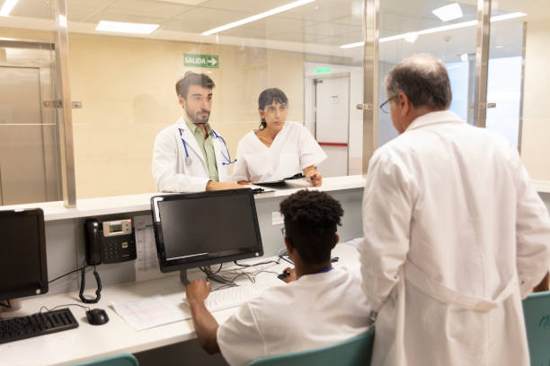 istock Young doctor talking to senior at doctor's office 1453088220