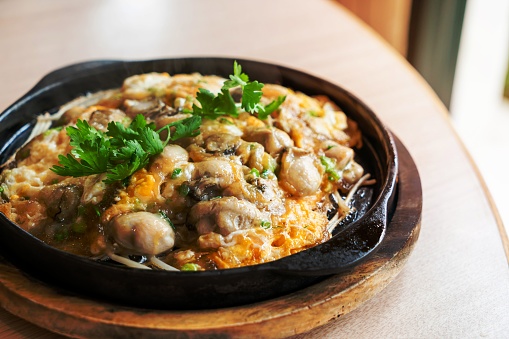 Oyster omelette with bean sprout on hot pan - Asian food style