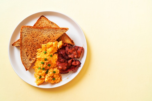 scramble egg with bread toasted and bacon for breakfast