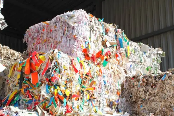 Wastepaper compact texture pile for recycling on sorting plant. Technology of reuse materials. Stack of shredded paper. Save the planet ecology concept. Industry of reduced pollution factory. Close-up